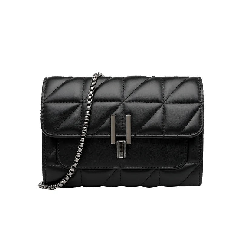 Black quilted leather handbag with a silver chain strap and unique clasp.