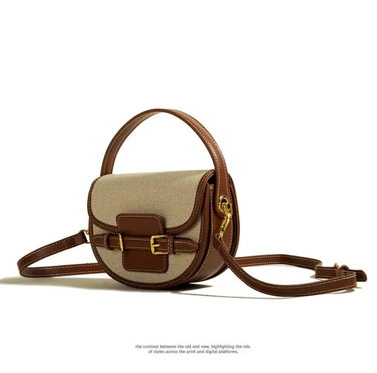 Two-tone brown and beige saddle bag with a gold buckle.