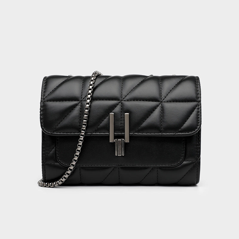 Black quilted leather shoulder bag with a silver chain and metal clasp.
