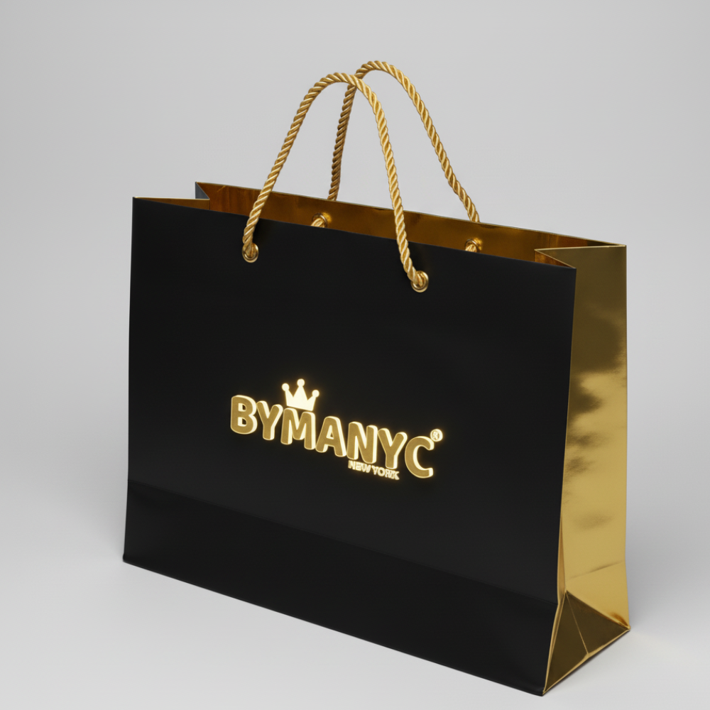 Black shopping bag with gold BYMANYC logo, gold handles, and accents.